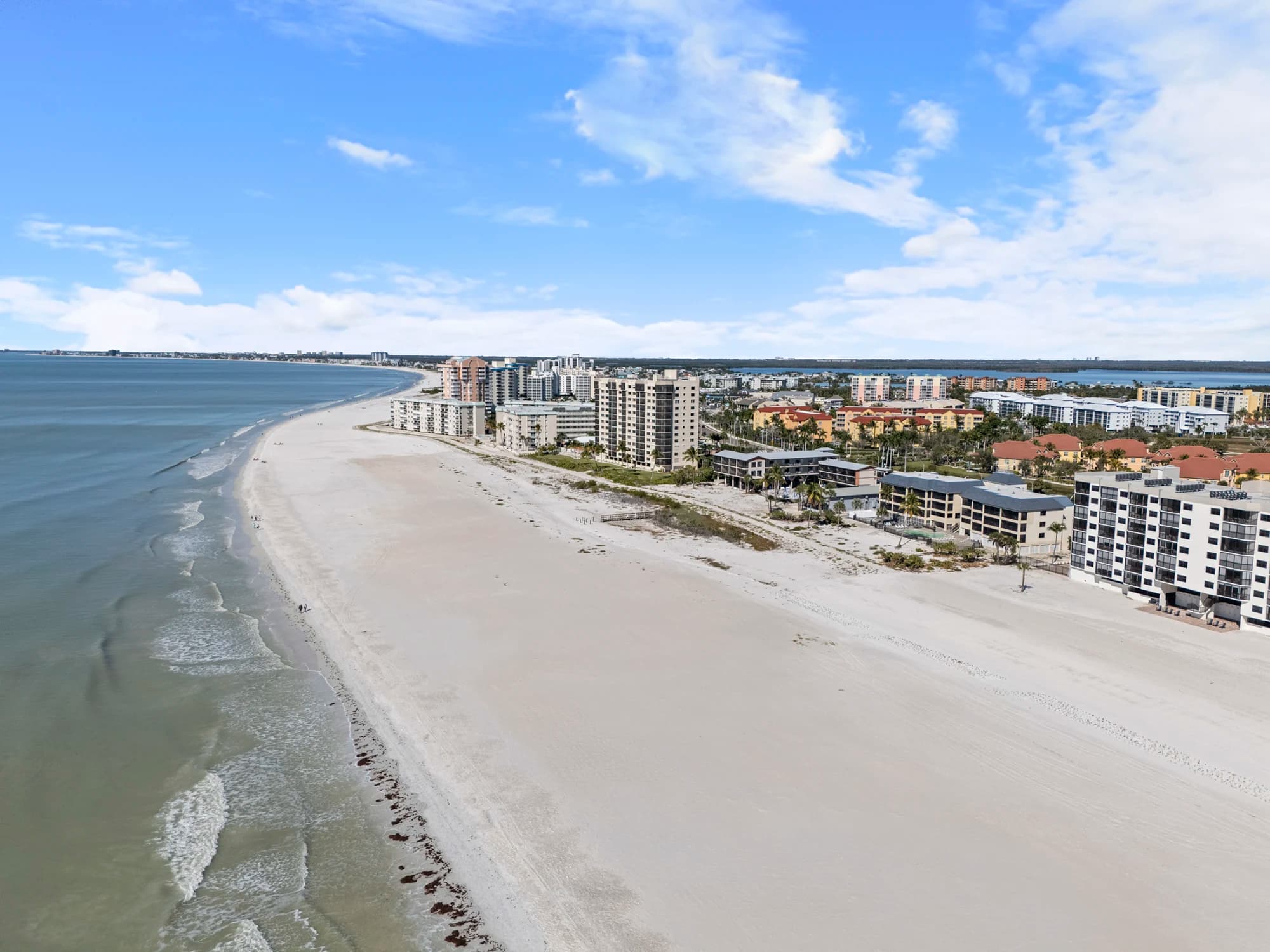 Aerial view of Fort Myers Beach coastline with white sand beaches and beachfront buildings